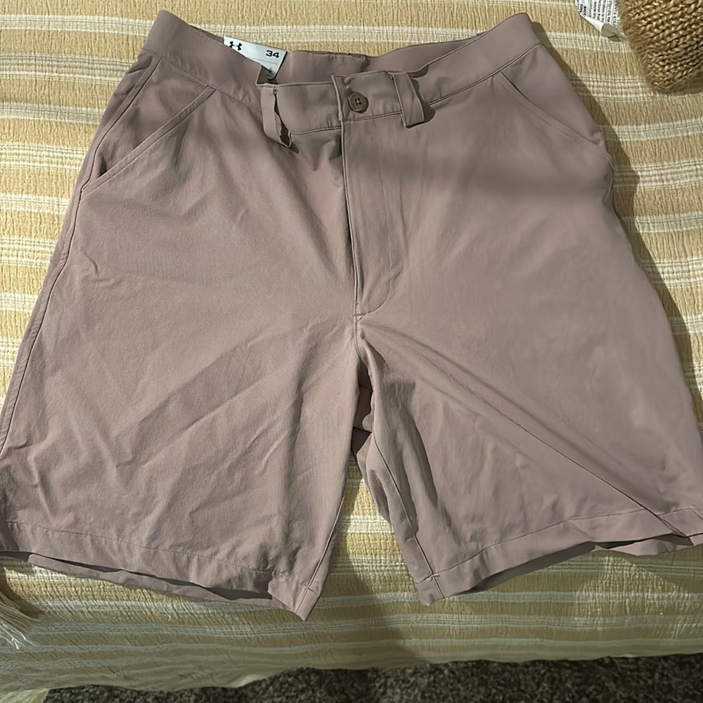 This a pair of brand new with tags under Armour golf shorts. Size 34 .